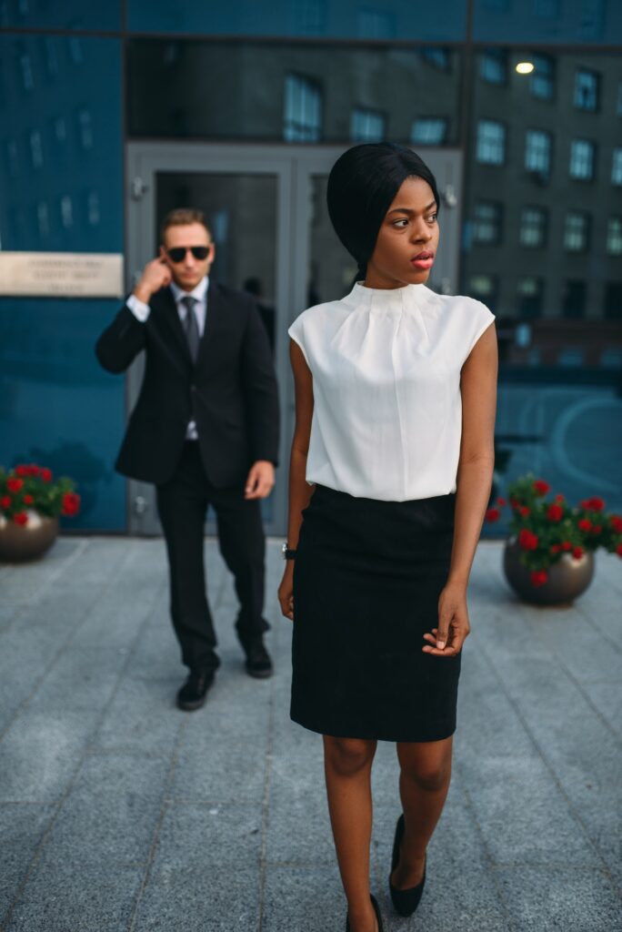 Business woman, bodyguard in suit on background