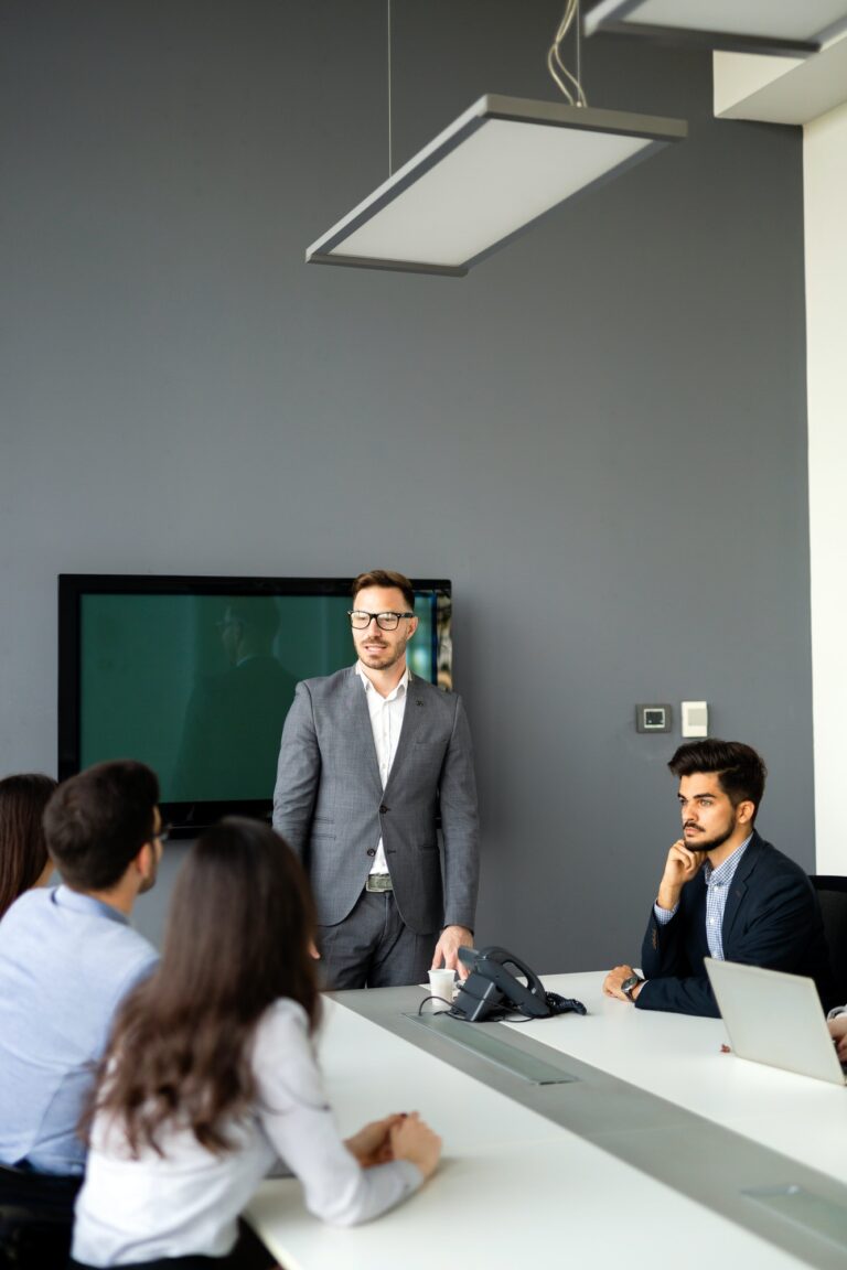 Group of lawyers discussing contract together in office